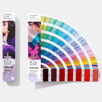 Pantone formula guide exhibited at IAAPA Expo Europe 2021, showcasing an array of color swatches for both coated and uncoated paper.