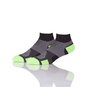A pair of Classic Gym Ankle Socks with neon green accents on a reflective surface.