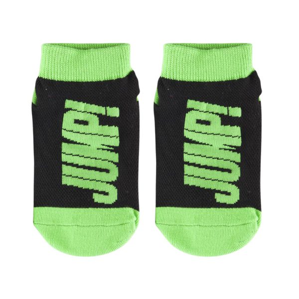 Pair of black and green Outdoor Trampoline Socks with the word "jump" written on the sole.