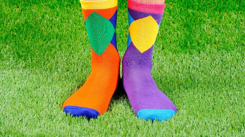 A pair of feet wearing bamboo fiber socks standing on the lawn