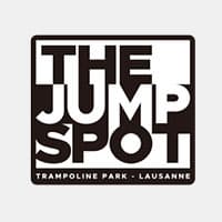 Logo for "The Jump Spot" trampoline park in Lausanne, with bold black and white text in a square design.