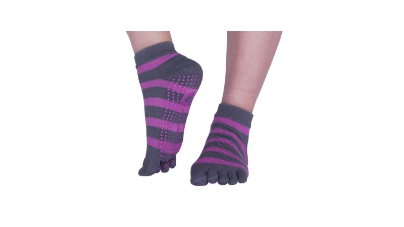 Feet in gray and purple striped Easy Steps toe socks with grip dots on a white background.