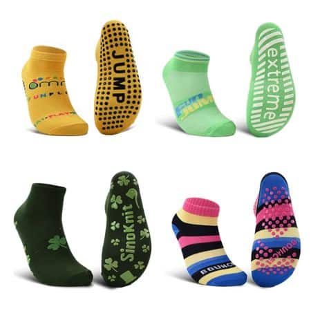 Four pairs of colorful trampoline socks with unique designs and non-slip words and patterns on the soles.