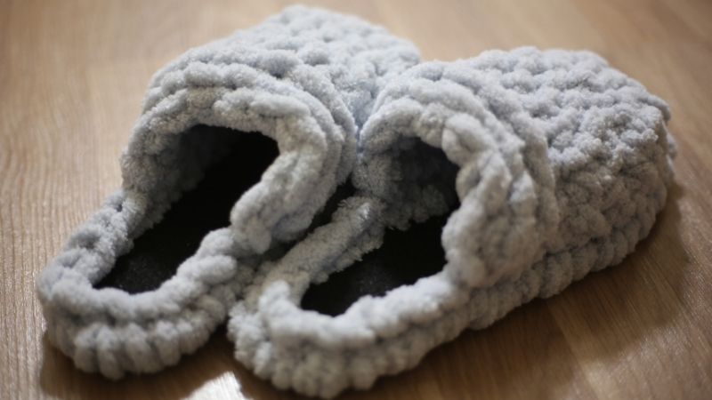 Soft gray plush slippers for cozy home comfort, perfect for lounging or relaxing. Ideal for adding warmth and style to your indoor wardrobe, available at Deepblue.