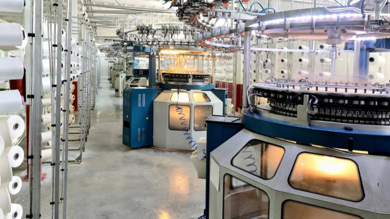 Modern sock manufacturing machinery in a high-tech factory, showcasing automated knitting and production processes for quality sock creation.