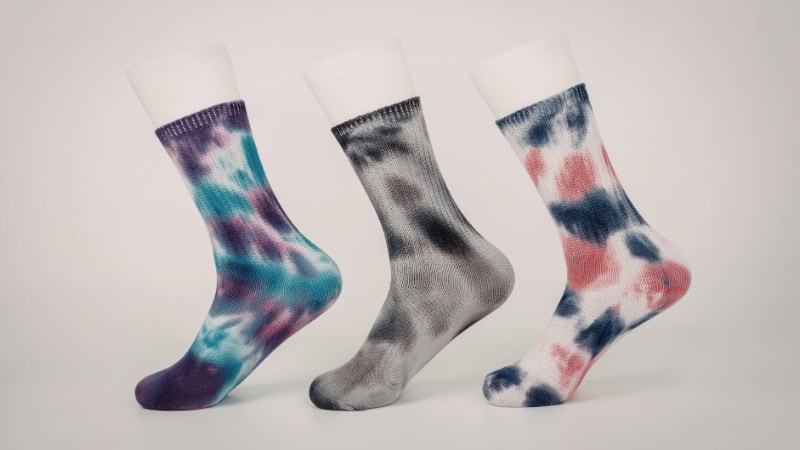 Bright, patterned socks showcasing different tie-dye designs, perfect for comfortable and stylish footwear.