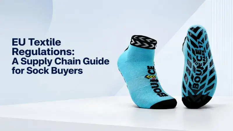 Close-up of a pair of blue athletic socks with black and blue sole pattern, emphasizing compliance with EU textile regulations for sustainable supply chains.